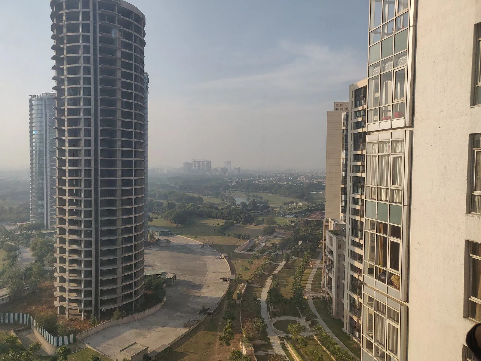 Tall residential towers with green land and new roads below